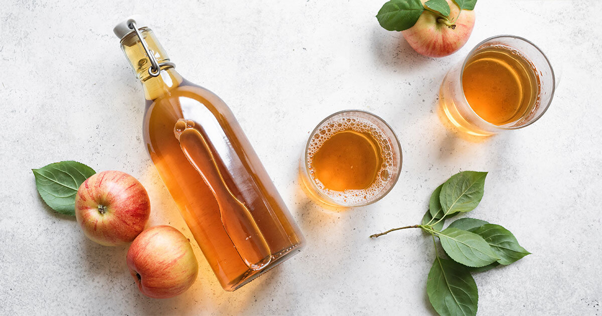 apples and apple cider on a table