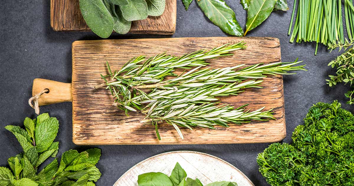 Antioxidant rich rosemary on a wodden cutting board